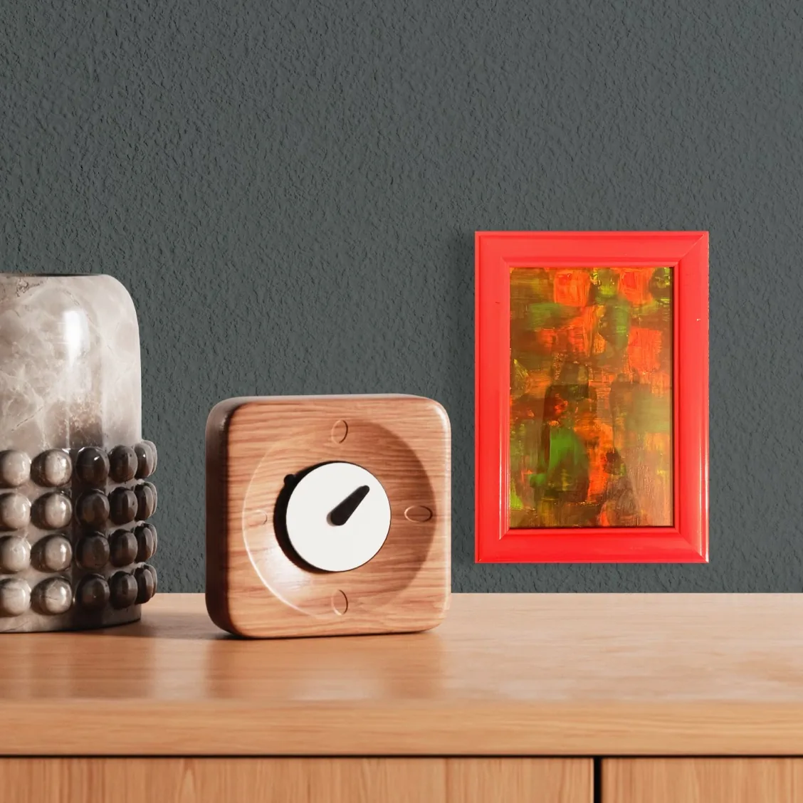 Abstract acrylic artwork featuring reds, greens, and oranges in a bright red frame.
