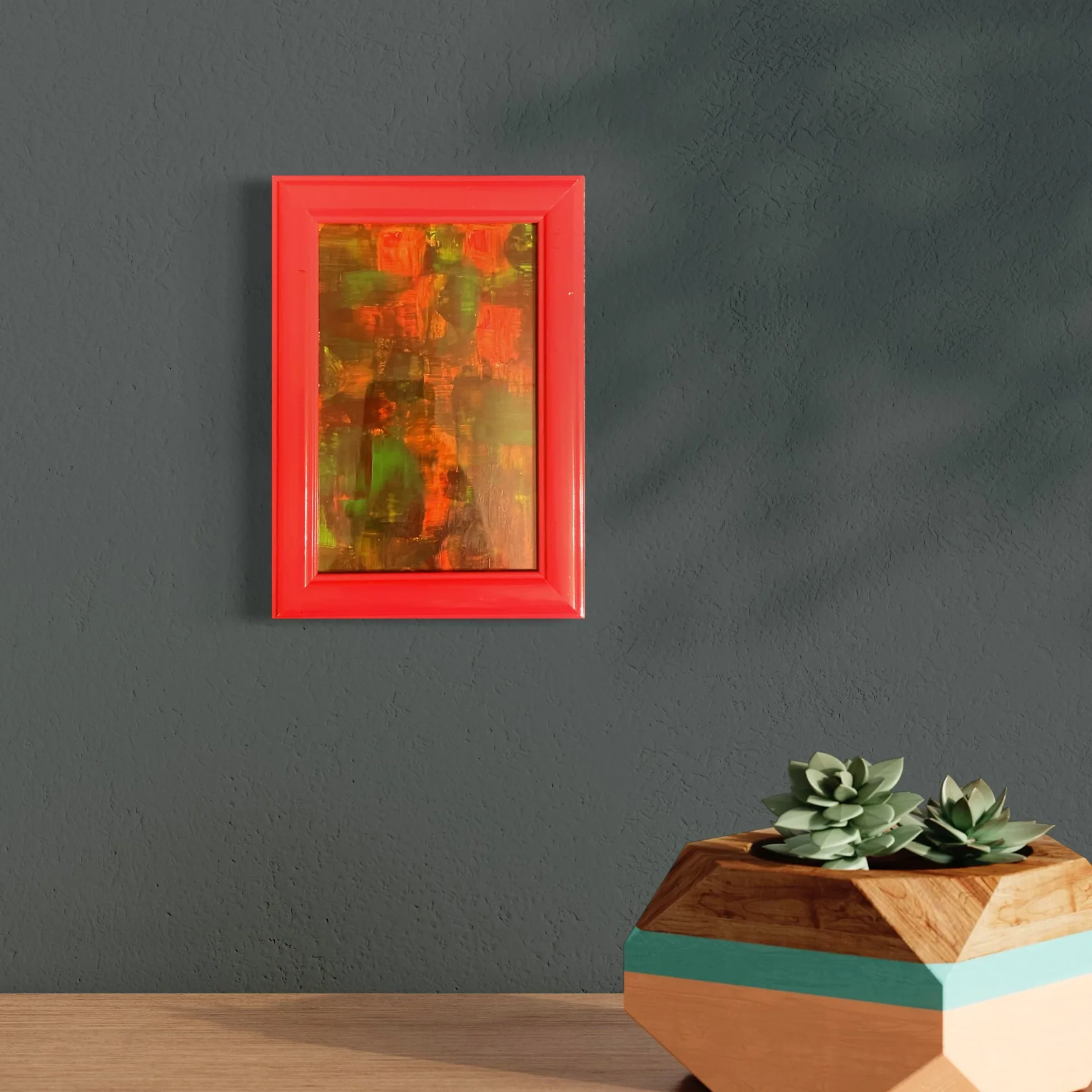 Vibrant abstract acrylic artwork featuring reds, oranges, and greens in a bright red frame.