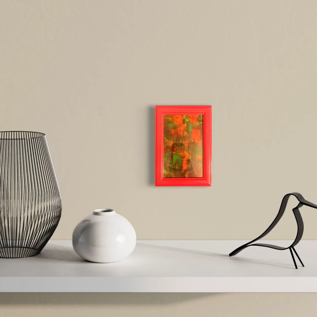 Vibrant abstract acrylic work featuring reds, oranges, and blacks in a red frame on a plain wall.