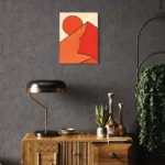 Abstract composition of red and orange shapes on a neutral gray wall.
