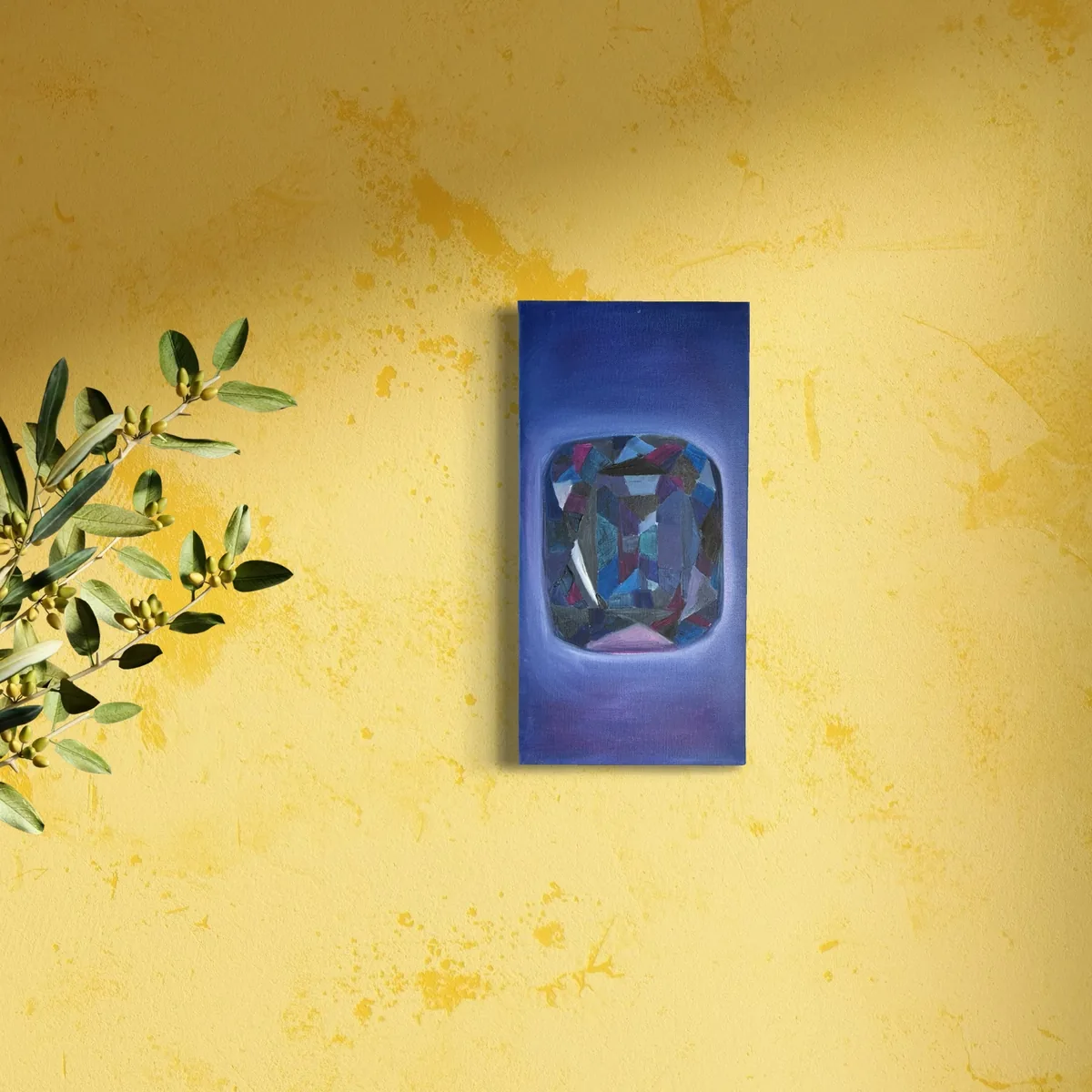 Blue and purple abstract jewel shape on a solid blue canvas against a yellow wall.