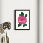 Vibrant pink watercolor rose with green leaves, framed art on a white wall.