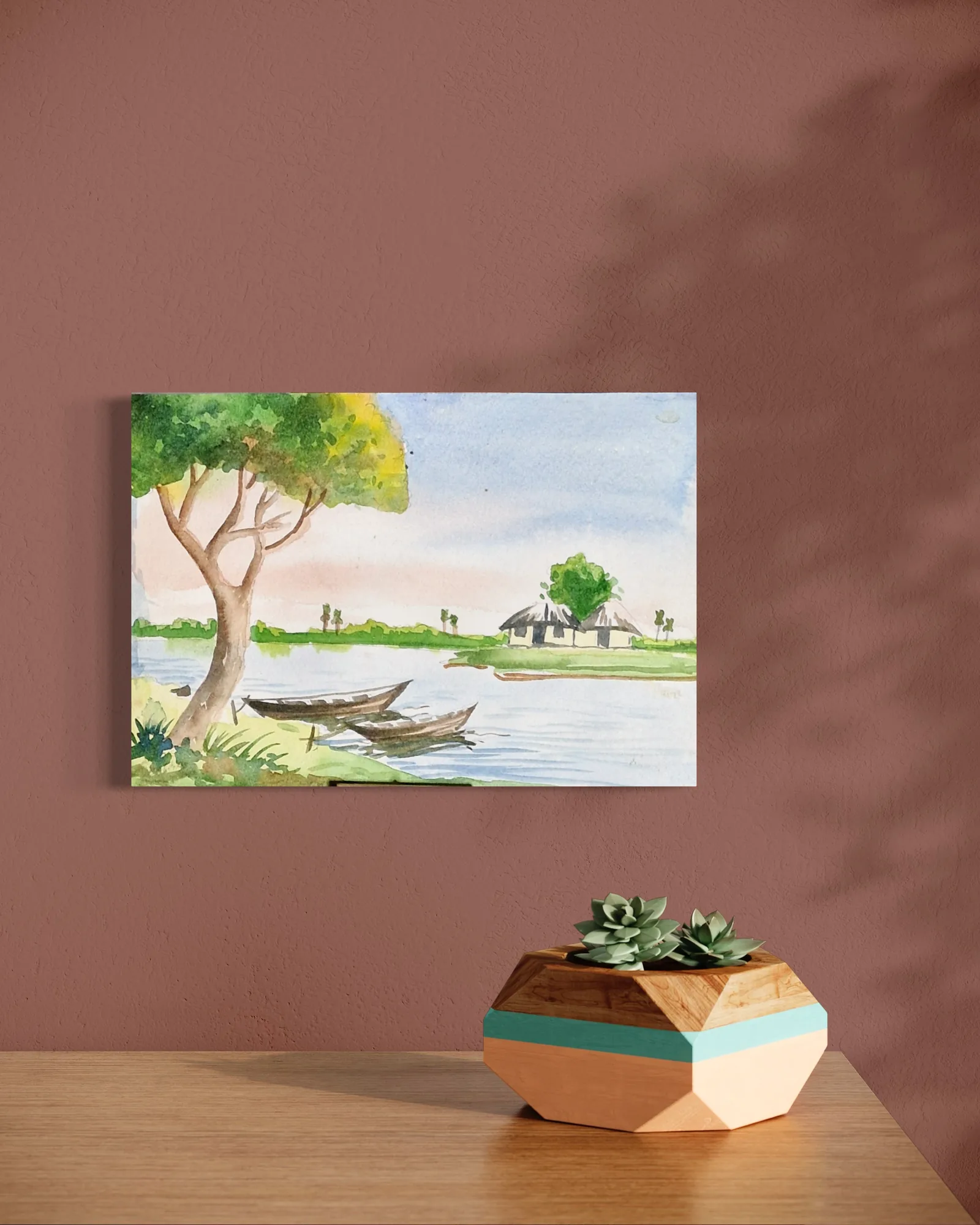 Watercolor scene of a river with trees, houses, and a bright sky.