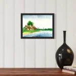Watercolor scene of green huts by a blue river under a bright sky, in a black frame.