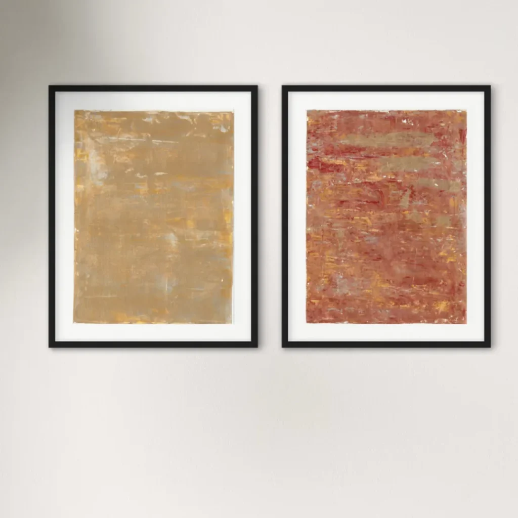 Abstract artwork featuring warm ochre and deep red tones in a black frame.